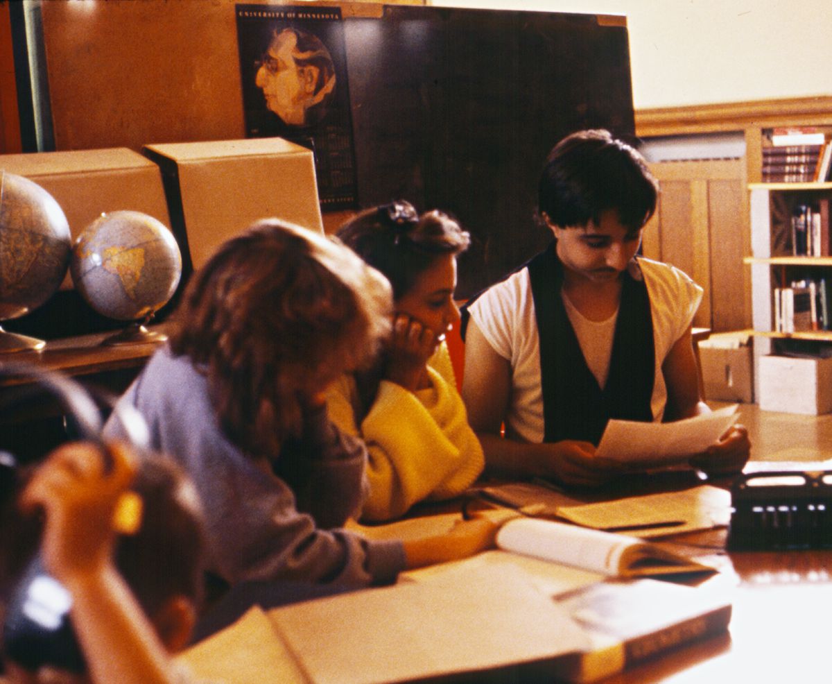 Three students doing library research